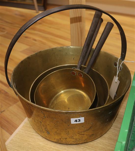 Three brass saucepans and a jam pan